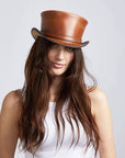 A woman wearing Hampton Cyprus Tan Leather Top Hat on an angle view 