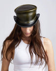 A woman wearing Hampton London Green Leather Top Hat 