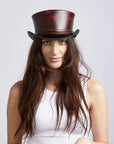 A woman wearing Hampton Napa Vino Leather Top Hat