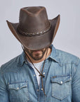 A man on a denim jacket wearing Hollywood Brown Leather Cowboy Hat 