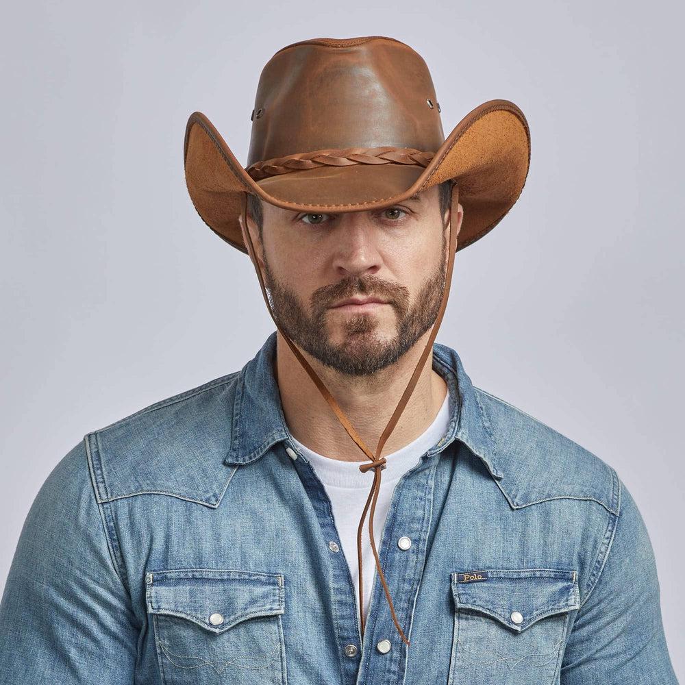 A man on a denim jacket wearing Hollywood Copper Leather Cowboy Hat 
