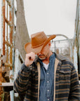 man standing in cattle pen wearing the Hollywood Copper Leather Cowboy Hat by American Hat Makers
