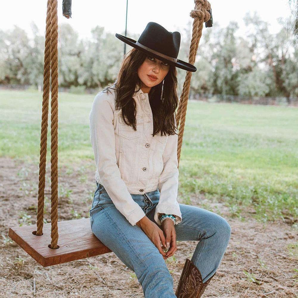 A woman on a swing wearing white tops and a Hudson Black Felt Fedora Hat 