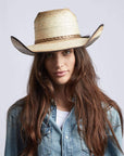 A woman in denim jacket wearing Laredo Straw Tan Cowboy Hat 
