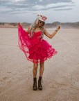a woman in pink dress wearing a Lola Silver Burning Man Hat on a desert