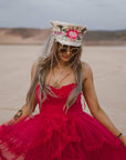 A woman in pink dress and wearing Lola Silver Burning Man Hat 