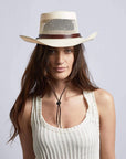 A woman in white tops wearing Madrid Straw Pork Pie Cream Sun Hat 