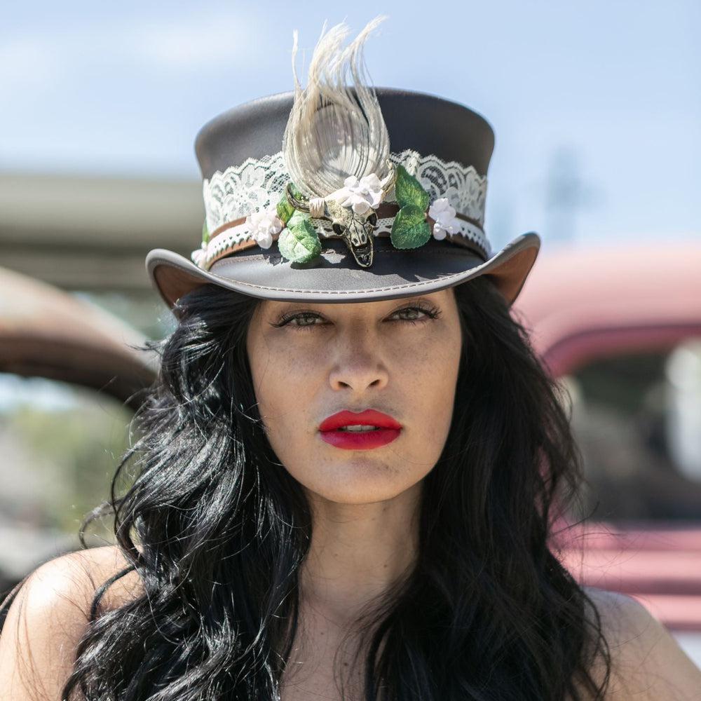 A woman wearing a top hat with True love beaded hat band