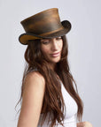 A woman wearing Unbanded Marlow Burnt Honey Finished Top Hat on an angle view 