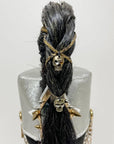 A mcqueen guard hat on a back view with skull accessories