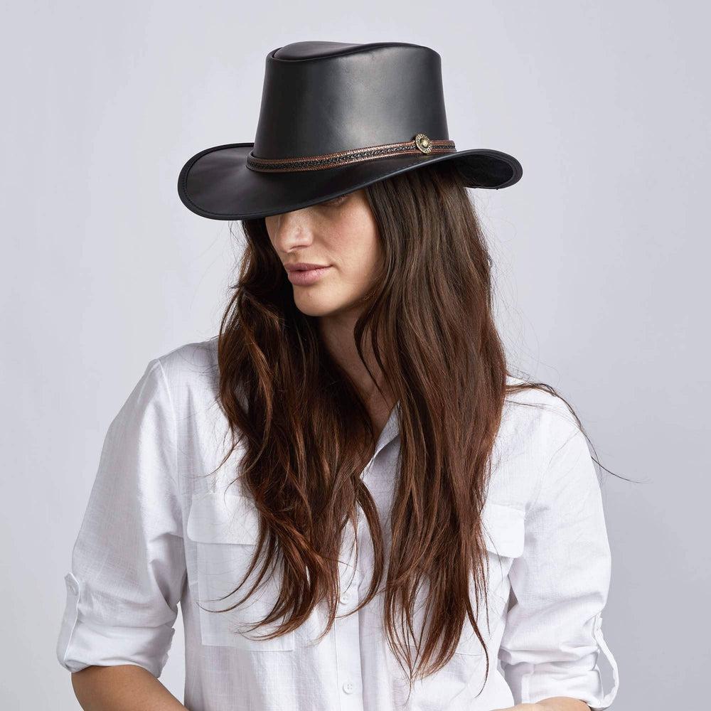 A woman wearing Midnight Black Rider Leather Hat on an angle view 