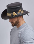 A man wearing Pale Rider Black Finished Top Hat with Rattlesnake Band on a side view