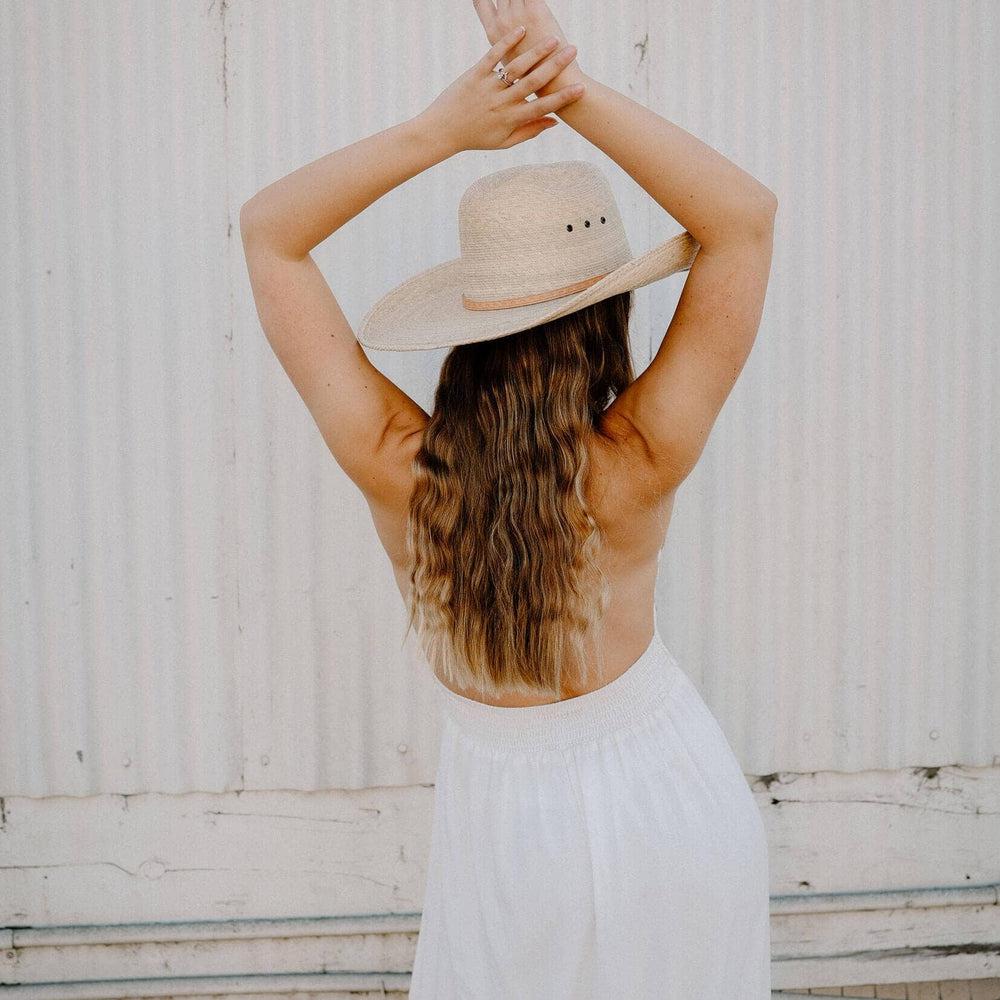 A back view of a woman wearing Natural Vaquero Tejano Palm Cowboy Hat 