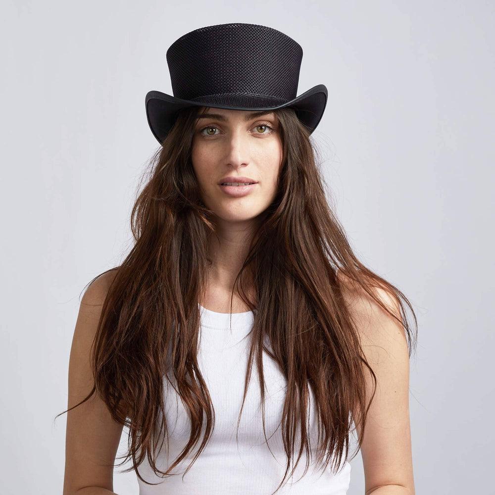 A woman wearing Unbanded Rogue Black Mesh Top Hat on a front view