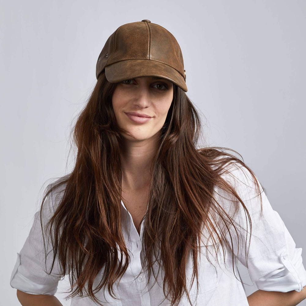 a woman in white polo wearing Sidecar Brown Leather Cap 