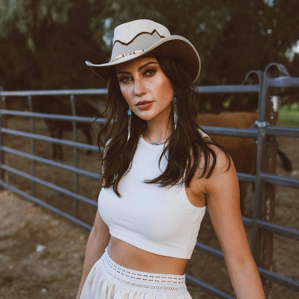A woman in a white tops wearing Leather Mesh Cowboy 