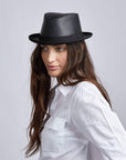 A woman wearing Soho Black Cowhide Leather Fedora on an angle view