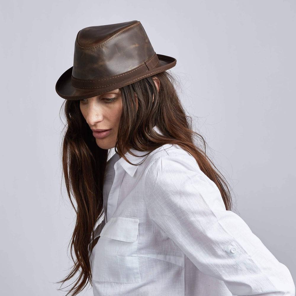A woman wearing Soho Chocolate Cowhide Leather Fedora on an angle view
