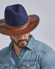 A man in denim jacket wearing Summit Navy Felt Leather Fedora Hat 