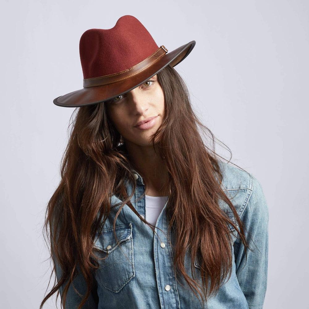 A woman in denim jacket and Sangria Leather Felt Fedora Hat on an angle view