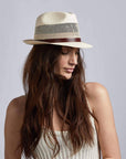 A woman wearing Tuscany Cream Straw Fedora Hat on a left view