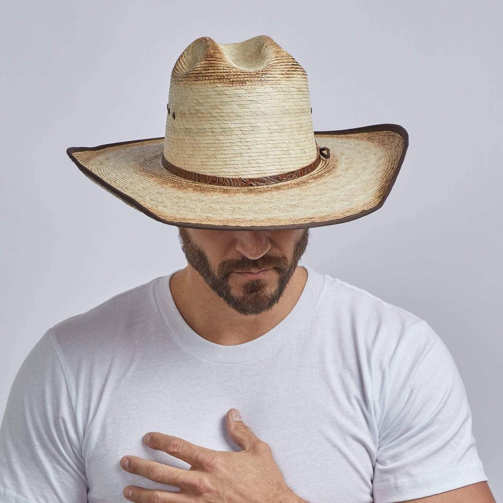 A man wearing Yuma Brown Palm Straw Cowboy Hat