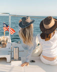 Two woman enjoying on a boat with an ocean view