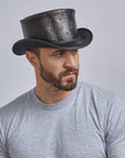 a man wearing the Royal Skull Leather Black Top Hat 
