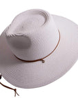 An angle view of Felix white straw sun hat with chinstrap 