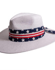 A side view of Knox white straw sun hat with US flag designed hat band