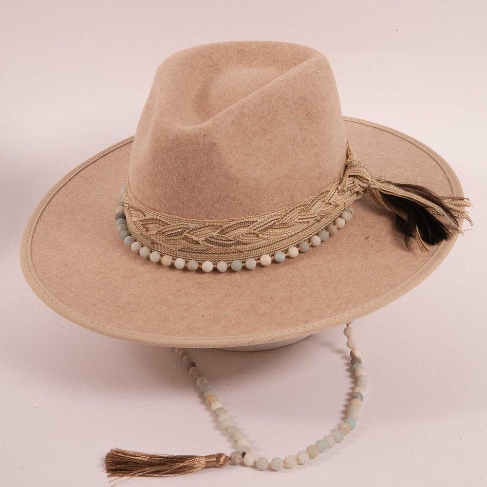 An angle view of a cream cowboy hat placed on a stand
