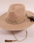 An angle view of a cream cowboy hat placed on a stand