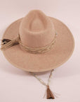 A top view of a cream cowboy hat with a beaded hat band