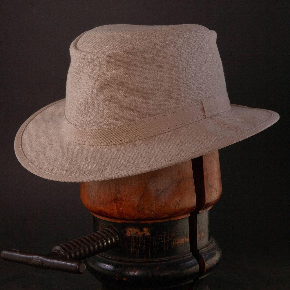 An Angle view of Rogan Hemp Fabric Khaki Sun Hat placed on a stand
