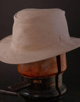 An Angle view of Rogan Hemp Fabric Khaki Sun Hat placed on a stand