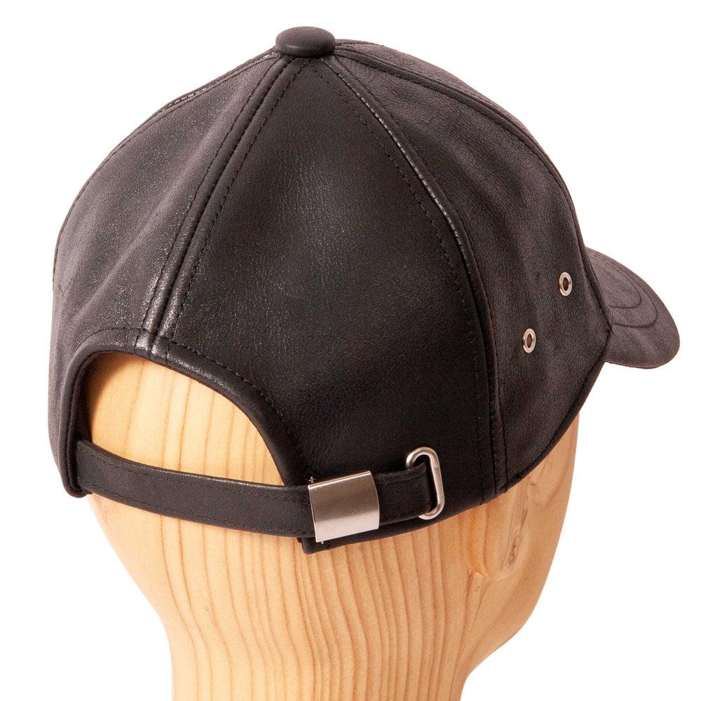 A back view of Sidecar Black Leather Cap for Men placed on a wooden stand