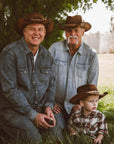 A family spending time outdoors wearing cowboy hats